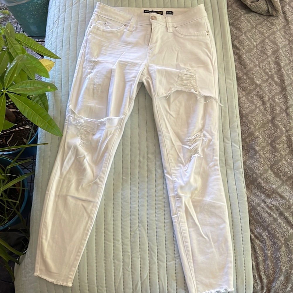 Different type of distress on The jeans. Never worn